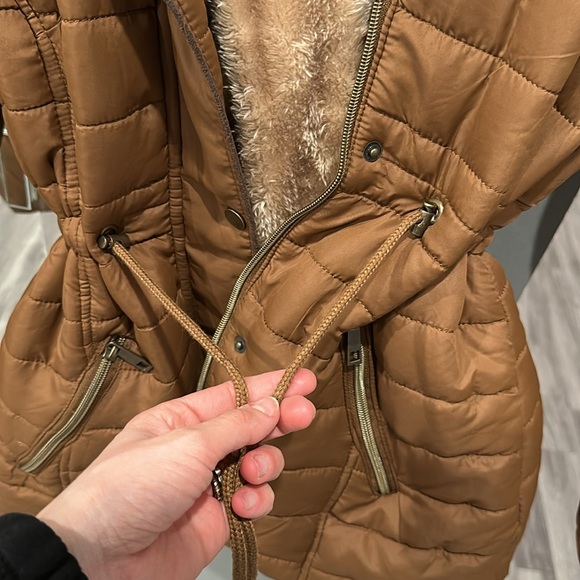 A Brown Puffer Jacket with tightness Adjustability and a removable hoodie. - Picture 4 of 5